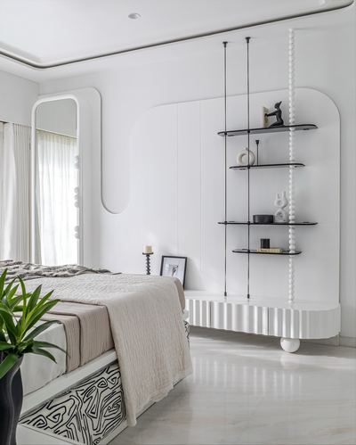 White minimalist bedroom with curved walls, suspended glass shelving, and beige textured bedding