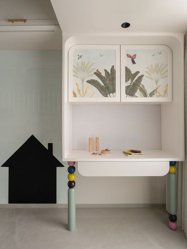 White curved study desk with tropical-print cabinet doors and colorful bead-shaped legs
