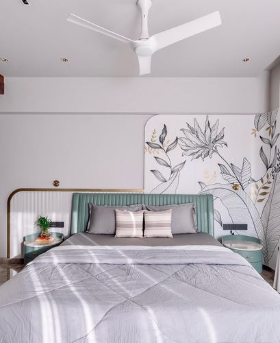 Bedroom with teal fluted headboard, floral mural wall, and round nightstands