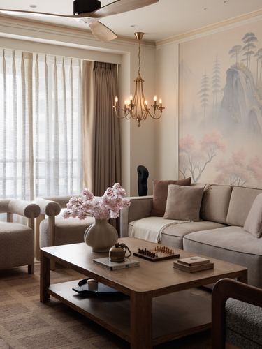 Neutral living room with boucle armchair, brass chandelier, wood coffee table and mural wall