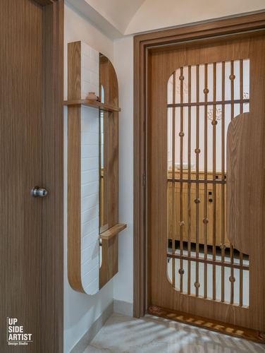 Foyer with an arched wooden mirror niche beside a slatted wooden door leading to a wardrobe unit.