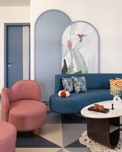 Living room with blue sofa, pink armchair, arched panels and marble coffee table