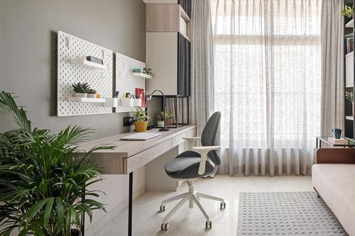 Minimal home study with wood desk, pegboard shelving, and sheer-curtained window