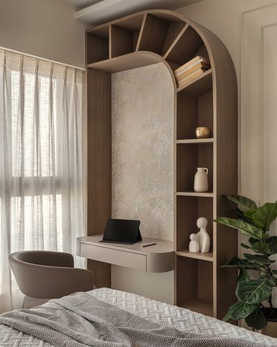 Curved wood arch shelving unit with built-in desk beside bed and sheer-curtained window