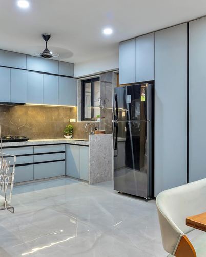 Modern powder-blue kitchen with gold-veined backsplash, marble-look floor and black refrigerator