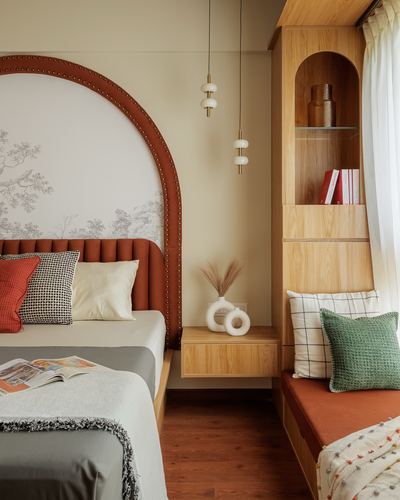 Bedroom corner with arched terracotta leather headboard and wooden arched shelving niche