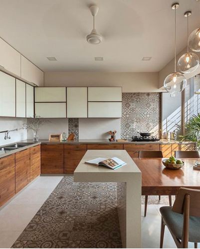 L-shaped wood kitchen with patterned tile backsplash and floor, cantilevered counter into dining table