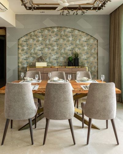 Dining room with six upholstered chairs around wood table, arched floral wall niche behind sideboard