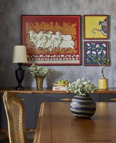 Dining sideboard with pichwai painting, folk art, brass and ceramic vases against textured grey wall