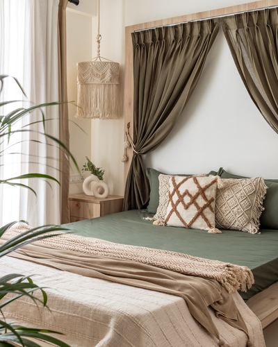 Bedroom corner with olive curtains framing headboard, macrame pendant light, and layered textured bedding