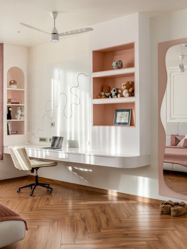 White floating desk with peach-backed shelving and herringbone wood floor in a child's study nook