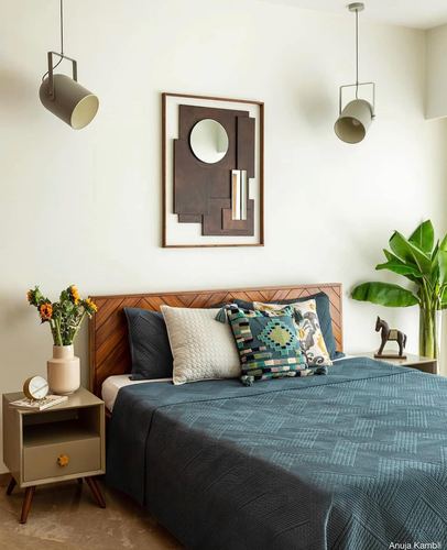 Minimalist bedroom with chevron wood headboard, teal bedding, and geometric mirror wall art