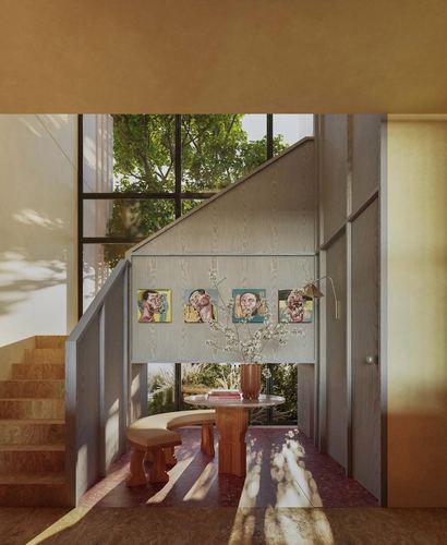 Sunlit staircase with underside dining nook, four portrait paintings, round table and curved bench on patterned floor