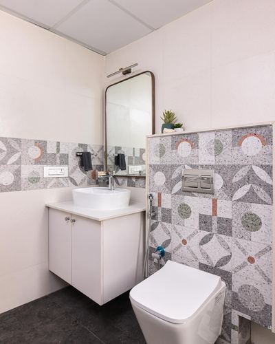 Bathroom with patterned terrazzo-look tile wall, floating vanity and wall-hung toilet