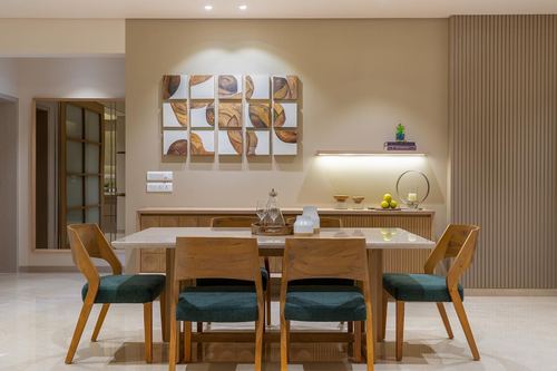 Dining room with wood chairs, marble-top table, and carved wood wall art panel