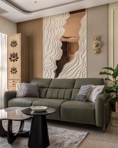 Living room with olive leather sofa beneath a carved wave-textured wall panel and lotus cabinet