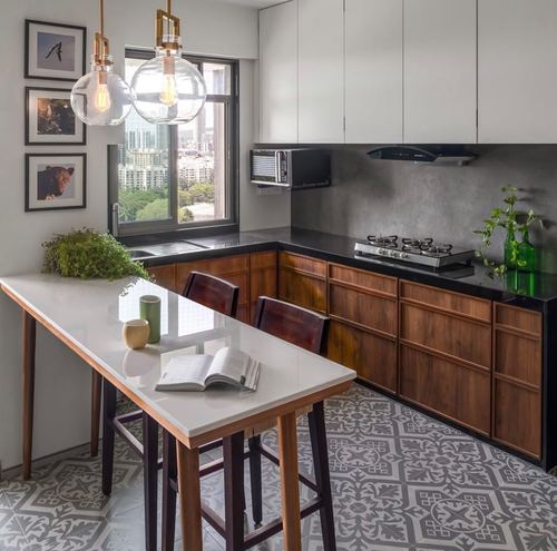L-shaped wooden kitchen with black countertop, patterned floor tiles, and city view window