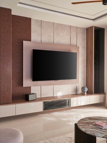 TV feature wall with marble and fluted wood panels above floating cabinetry