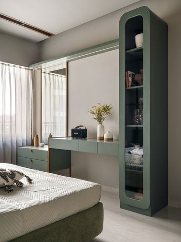 Sage green vanity and rounded tall display cabinet beside bed with sheer curtains