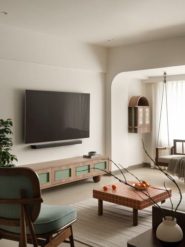 Beige living room with wall-mounted TV, wood console, tiled coffee table, and arched opening to a swing seat.