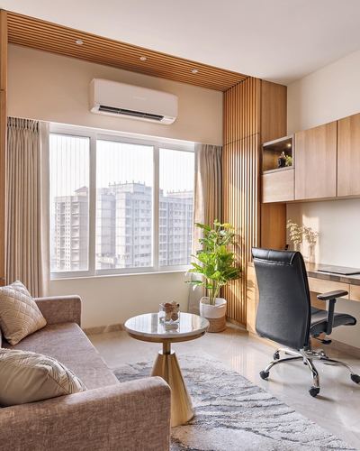 Beige living room corner with fluted wood panelling, built-in desk, sofa and city view window