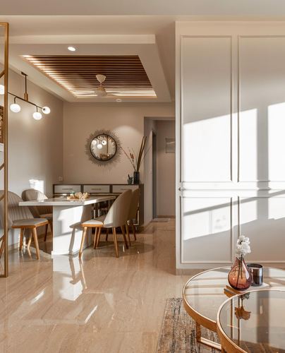 Sunlit dining area with marble floor, slatted wood ceiling, sunburst mirror, and glass coffee table in foreground