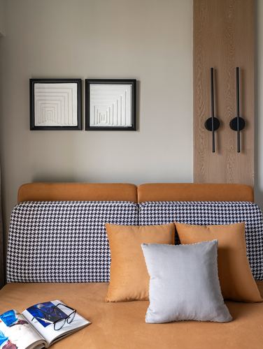 Mustard leather bed with houndstooth panel, twin framed art, wood wall with vertical sconces
