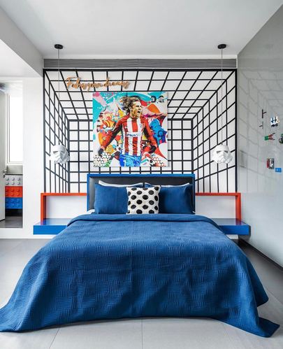 Kids bedroom with blue bed, orange floating nightstands, and 3D grid wallpaper behind a football pop art canvas