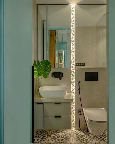 Small bathroom with vessel sink, patterned floor tiles, and backlit decorative wall strip