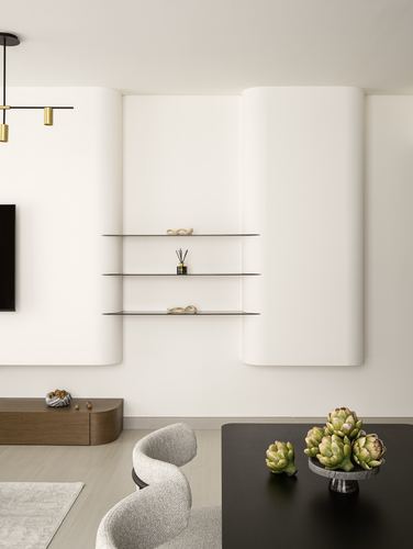 White curved plaster wall with floating shelves above a black dining table and boucle chairs