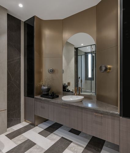 Bathroom vanity with arched mirror, marble countertop, and geometric patterned floor