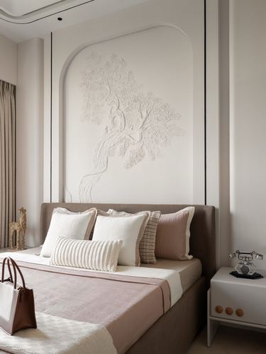 Bedroom with upholstered headboard, layered pillows, and carved tree relief panel above bed