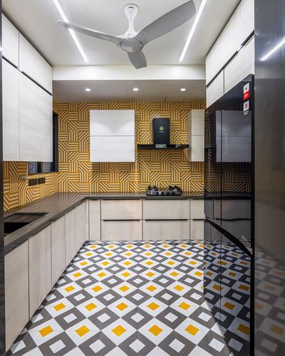 Modern kitchen with mustard geometric wallpaper, diamond patterned floor, and black glossy fridge