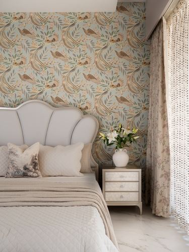 Bedroom with scalloped upholstered headboard, floral wallpaper, marble floor, and sheer floral curtains