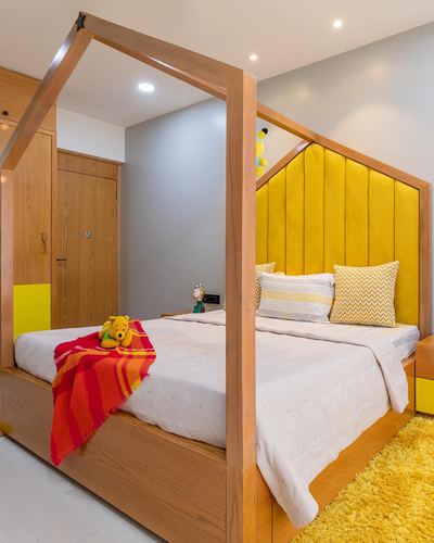 Child's bedroom with house-shaped wooden canopy bed and yellow tufted headboard