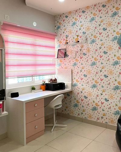 Pink desk with drawers, printer, and floral wallpaper in a girl's study corner
