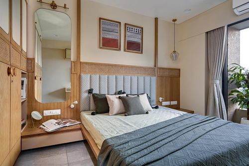 Bedroom with cane headboard, wood panelling, arched mirror and a study nook with an open book