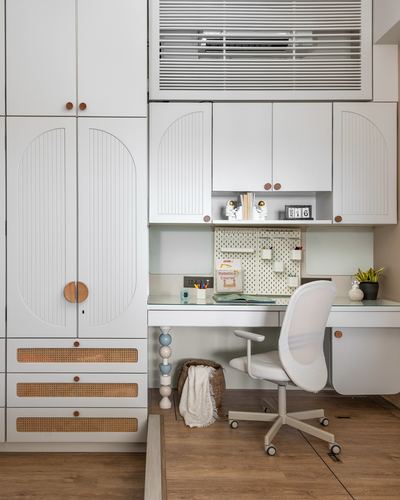 White study nook with arched wardrobe doors, cane drawers, pegboard desk and rolling chair
