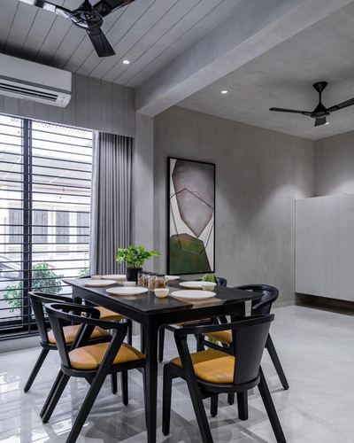 Grey dining room with black table, mustard leather chairs, and abstract wall art