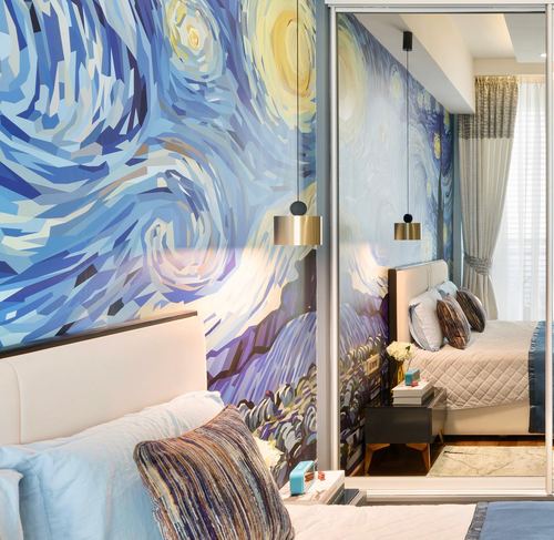 Bedroom with a Van Gogh-style mural wall, brass pendant light, white upholstered bed, and mirrored wardrobe reflecting the room.