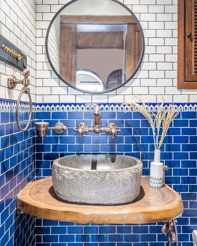 Bathroom with cobalt tile, round mirror, live-edge wood vanity and stone vessel sink