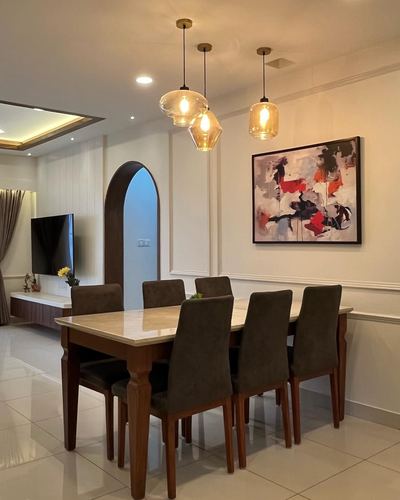 Dining room with marble-top wood table, cluster pendant lights and abstract art on paneled wall