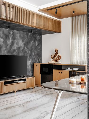 Living room with fluted wood ceiling box, dark textured wall, wood console and marble table