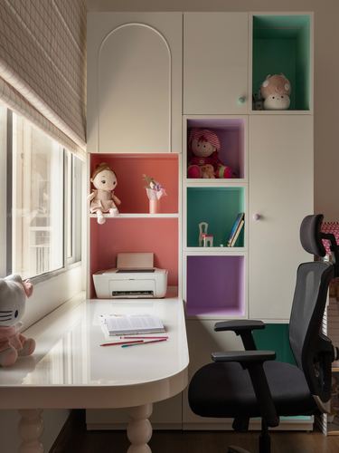 Child's study nook with colorful cubby shelves, white desk, and office chair by window