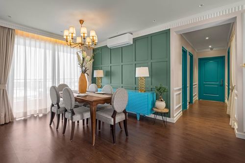 Dining room with wood table, oval chairs, teal panel wall, turquoise console and hallway with teal doors beyond