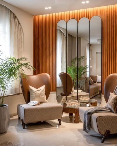 Living room with tan leather wingback chair, arched mirror panels, and fluted wood wall