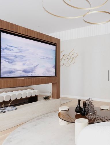 Minimalist living room with wood media wall, stone platform, round table, and gold ring chandelier