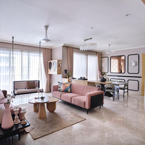Open-plan living and dining room with pink velvet sofa, hanging swing, and marble flooring