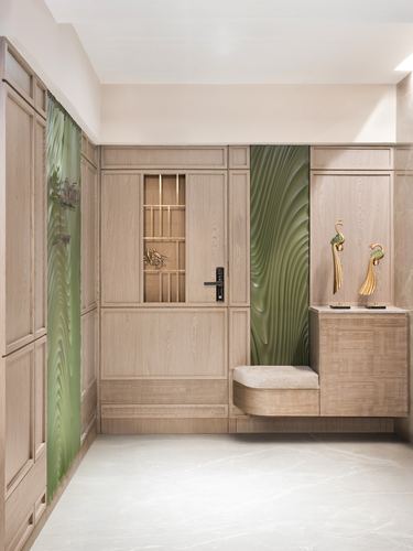 Foyer with light wood paneling, glazed door, green textured panel, and floating bench with gold bird sculptures