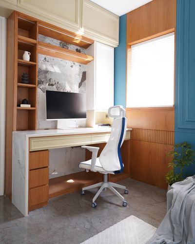 Home office nook with wood shelving, marble desk, and white ergonomic chair beside teal wall
